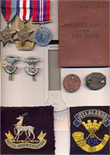 Dennis Solly's medal, badges, service books and other things he was issued with during the war.