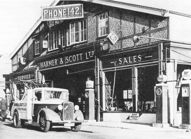 Photograph. Car outside Harmer & Scott Ltd (North Walsham Archive).