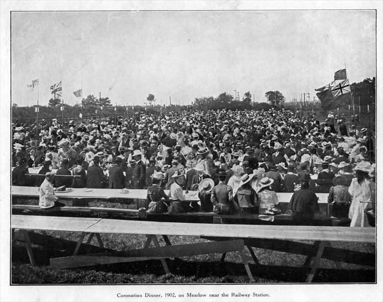 Photograph. Coronation Dinner for Edward V11, 1902, on meadow between the railway stations. (North Walsham Archive).