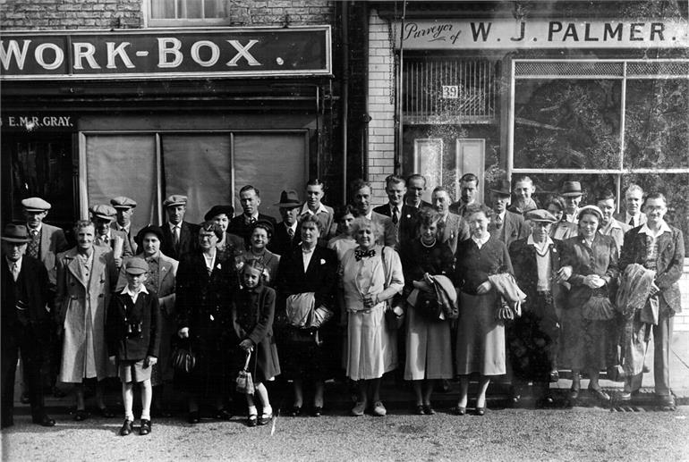 Photograph. Crowd waiting outside the Workbox. (North Walsham Archive).
