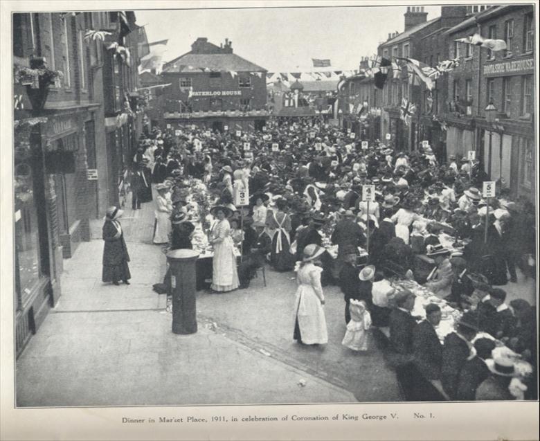Photograph. Dinner in the Market Place during the celebrations for the Coronation of George V. (North Walsham Archive).