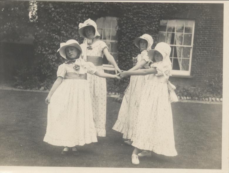 Photograph. Elizabeth and Barbara Blewitt dance with Nancy and Jean Hart (daughters of Dr. Hart) at Aylsham House in the 1920's. (North Walsham Archive).