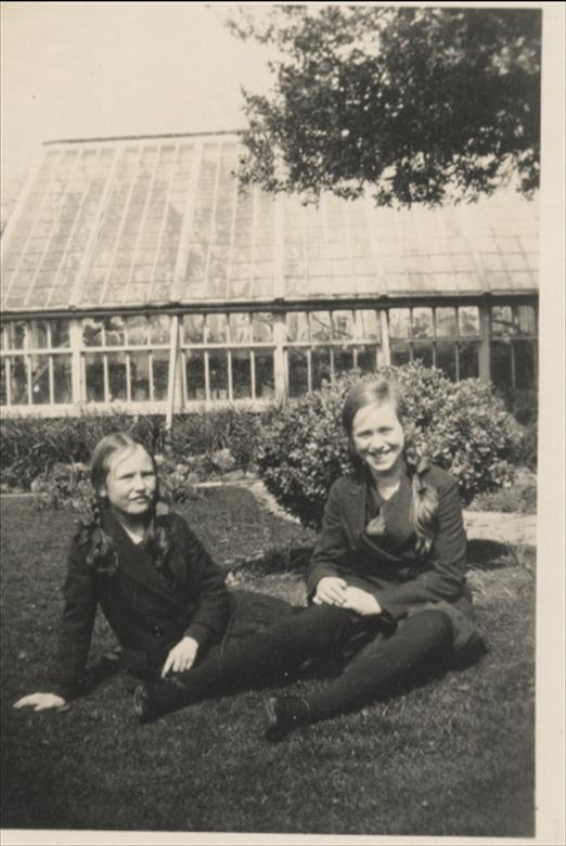 Photograph. Elizabeth and Barbara Blewitt in front of greenhouse at Aylsham House, North Walsham. (North Walsham Archive).