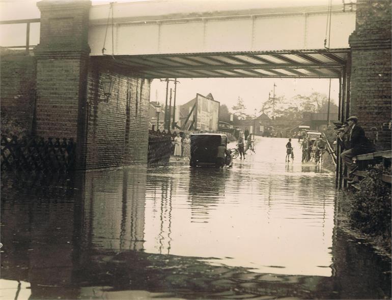 Photograph. Flood under Midland and Great Northern Joint Railway line bridge, Norwich Road. (North Walsham Archive).