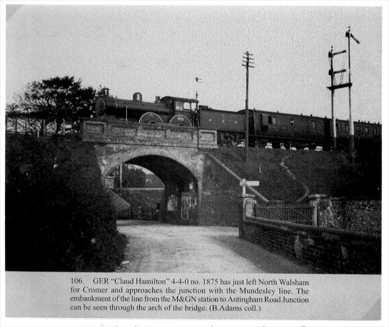Photograph. GER "Claud Hamilton" 4-4-0, No.1875, crossing Aylsham Road on North Walsham's "Main" line towards Cromer. (North Walsham Archive).