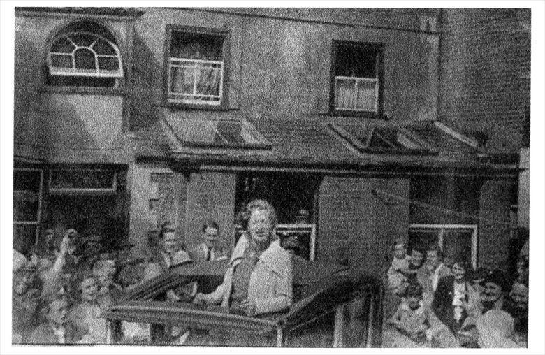 Photograph. Gracie Fields in the yard behind the Kings Arms Hotel, North Walsham. (North Walsham Archive).