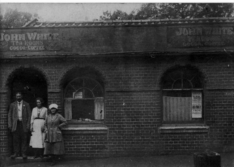 Photograph. John (Joe) White before his Tea Rooms, with family, in Kings Arms Street, North Walsham. (North Walsham Archive).