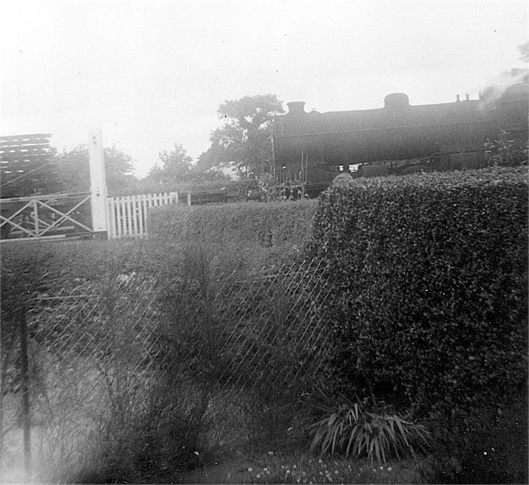 Photograph. Last train through Station Road crossing (North Walsham Archive).