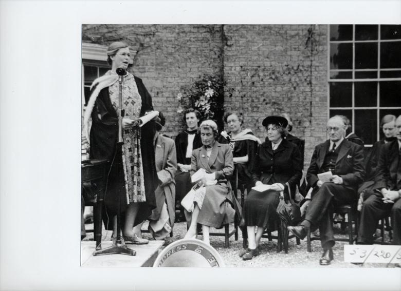 Photograph. Miss M S Middlewood, Head North Walsham Girls' High School 1947...1967, conducts Prize Giving outside before the new hall was built. (North Walsham Archive).