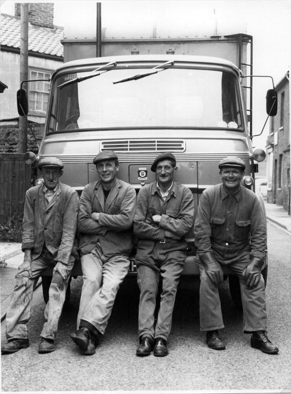Photograph. The North Walsham Dust Cart Crew posing at the top of Vicarage Street (North Walsham Archive).