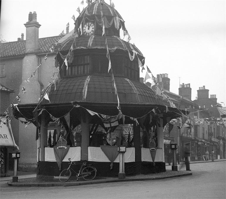 Photograph. North Walsham Market Cross decorated for the Coronation of King George VI - 12th May 1937. (North Walsham Archive).