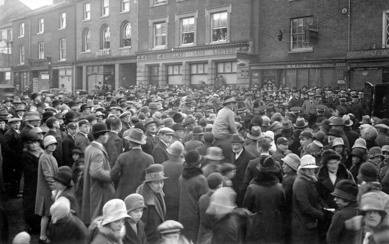 Photograph. Crowd for North Walsham's first motor ambulance in Market Place (North Walsham Archive).