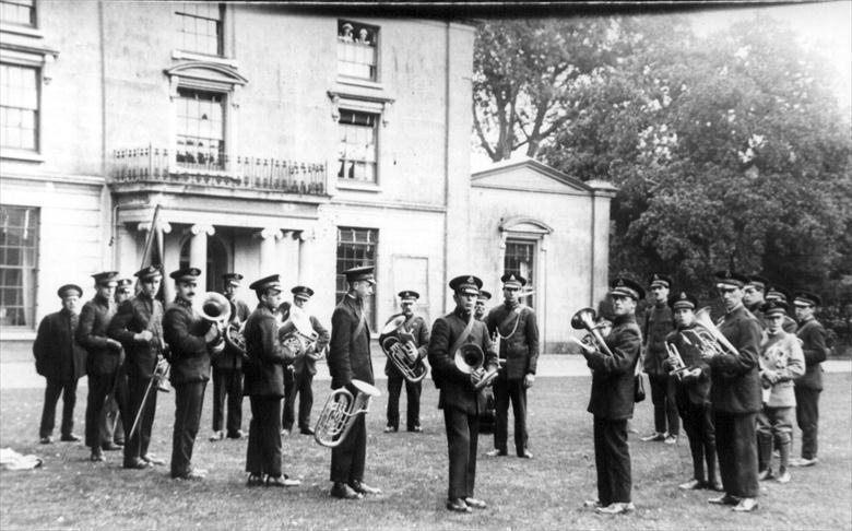 Photograph. North Walsham's Salvation Army Band outside The Oaks (North Walsham Archive).
