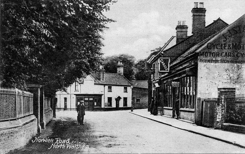 Photograph. Norwich Road, North Walsham. J.J.Starling on the right, Bull Inn in the distance. Photo taken before Frank Mann built his garage on the far right. (North Walsham Archive).
