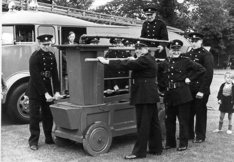Photograph. The rebuilt North Walsham fire pump exhibited after its restoration by the Fire Service (North Walsham Archive).
