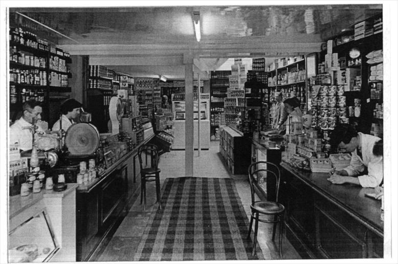 Photograph. Refurbishment of Rackstraws Grocery, 16 Market Street. Jack Laws on left, Dennis Allen, far right and Oliver Fisher on right.. (North Walsham Archive).