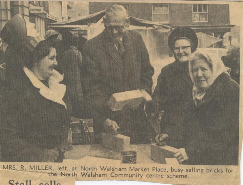 Photograph. Selling bricks at 2s..6d each to raise money for a Community Centre in North Walsham. (North Walsham Archive).