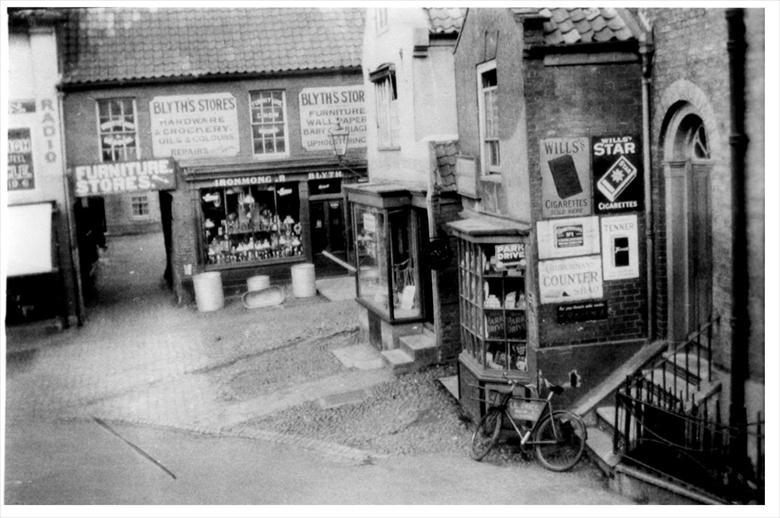 Photograph. top of.Market Street , North Walsham, looking north through arch to Mitre Tavern Yard. (North Walsham Archive).